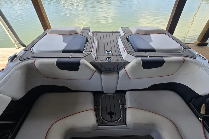 Slide: The Image of Interior of a 2018 Natique GS20 boat with cushioned seating and cup holders. - 9