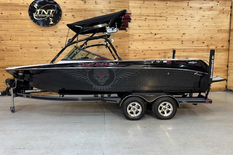 The Image of 2009 Nautique Super Air Nautique 210 Byerly boat on trailer, black with custom graphics. - 1