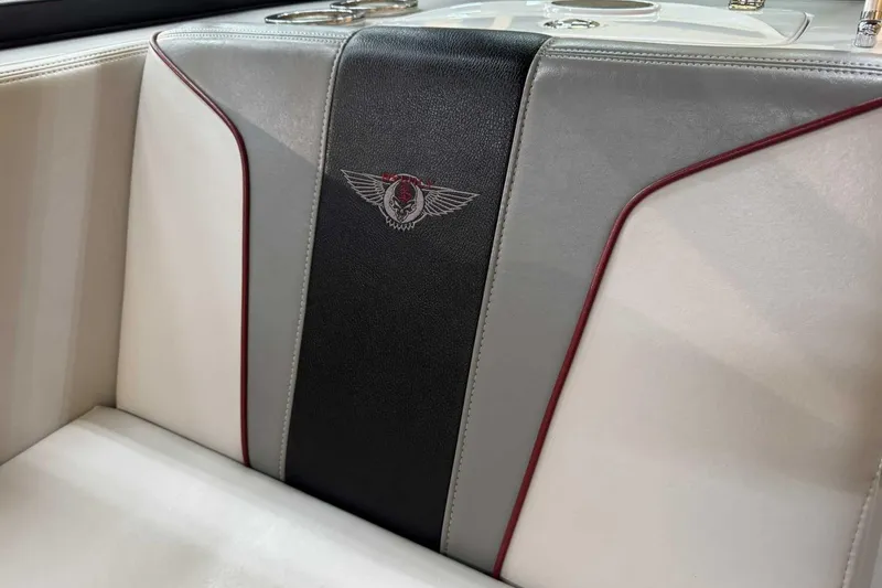 Slide: The Image of 2009 Nautique Super Air Nautique 210 Byerly boat seat with logo, featuring gray and black upholstery. - 14