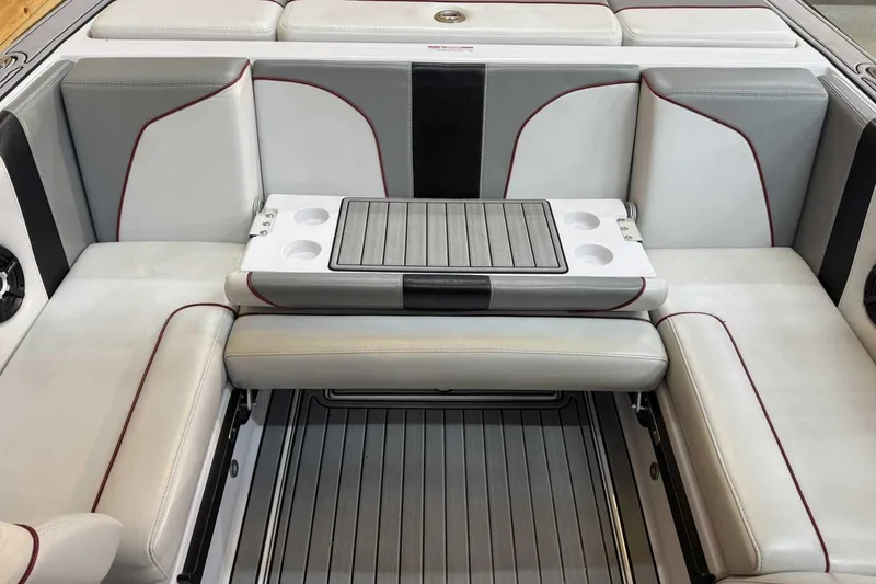 Slide: The Image of 2009 Nautique Super Air Nautique 210 Byerly boat interior with sleek seating and cup holders. - 17