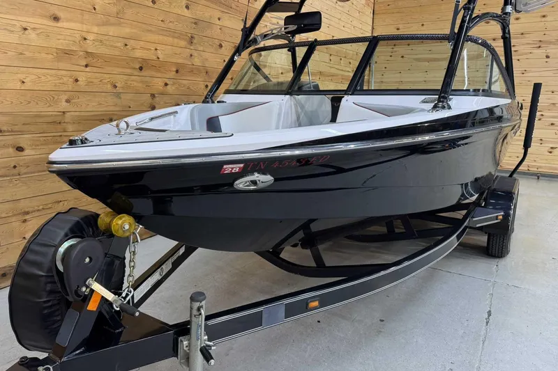 Slide: The Image of 2009 Nautique Super Air Nautique 210 Byerly boat on trailer in wooden garage. - 4