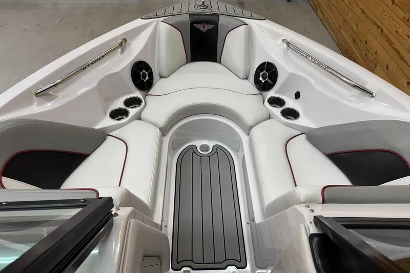 Slide: The Image of 2009 Nautique Super Air Nautique 210 Byerly boat interior with white seating and cup holders. - 9