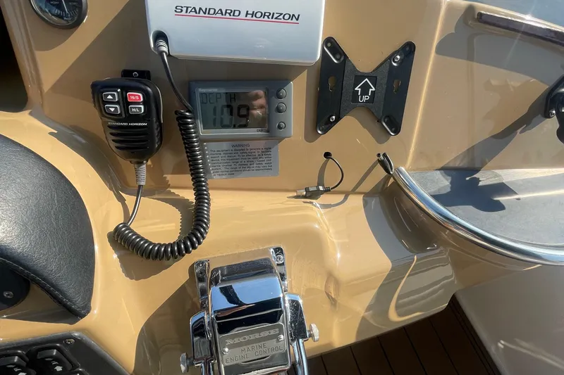 Slide: The Image of Control panel of a 2002 Carver 346 Aft Cabin with marine radio and depth gauge. - 12