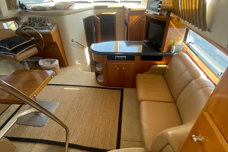 Slide: The Image of Luxurious interior of 2002 Carver 346 Aft Cabin yacht with leather seating and modern amenities. - 14