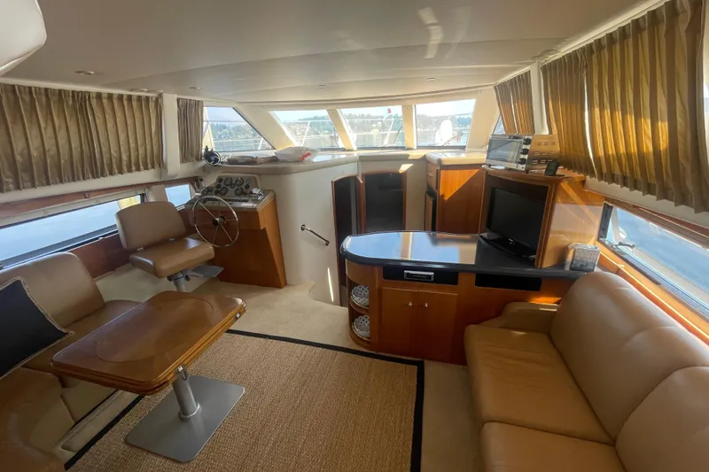 Slide: The Image of Luxurious interior of 2002 Carver 346 Aft Cabin yacht with leather seating and helm station. - 15