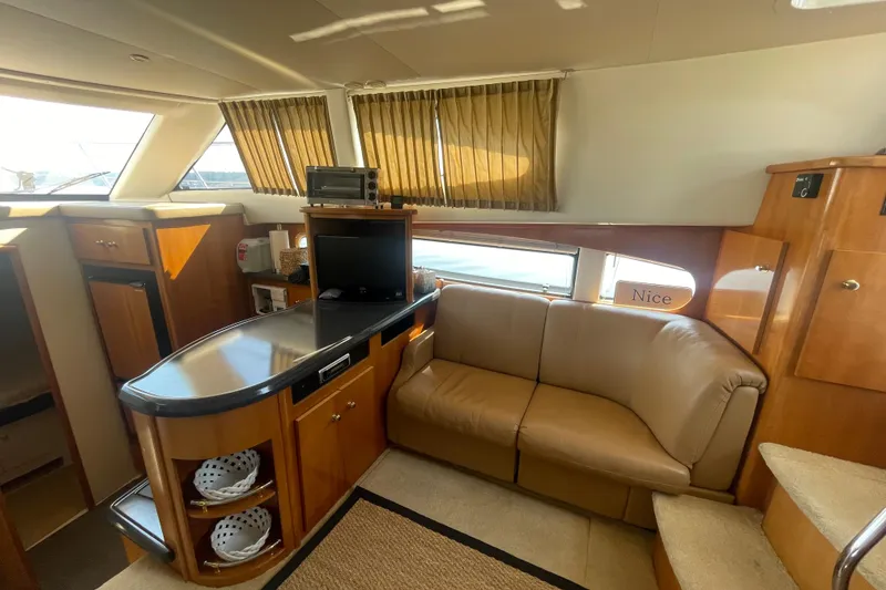 Slide: The Image of Interior of 2002 Carver 346 Aft Cabin yacht with cozy seating and modern amenities. - 16
