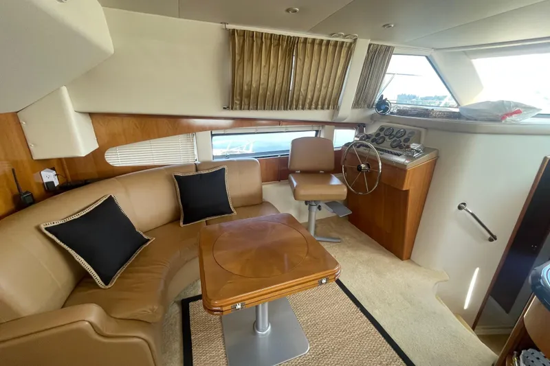 Slide: The Image of Interior of 2002 Carver 346 Aft Cabin with seating, helm, and wooden accents. - 19