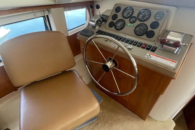 Slide: The Image of Helm of 2002 Carver 346 Aft Cabin with steering wheel and control panel. - 20
