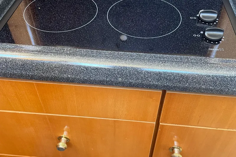 Slide: The Image of Ceramic cooktop on 2002 Carver 346 Aft Cabin yacht with wooden cabinetry. - 24