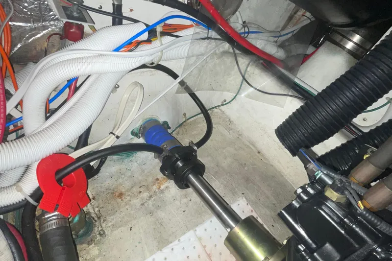 Slide: The Image of Engine compartment of a 2002 Carver 346 Aft Cabin with visible wiring and hoses. - 29