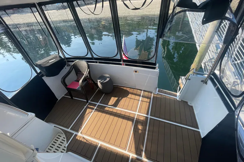 Slide: The Image of 2002 Carver 346 Aft Cabin boat interior with seating and water view. - 3