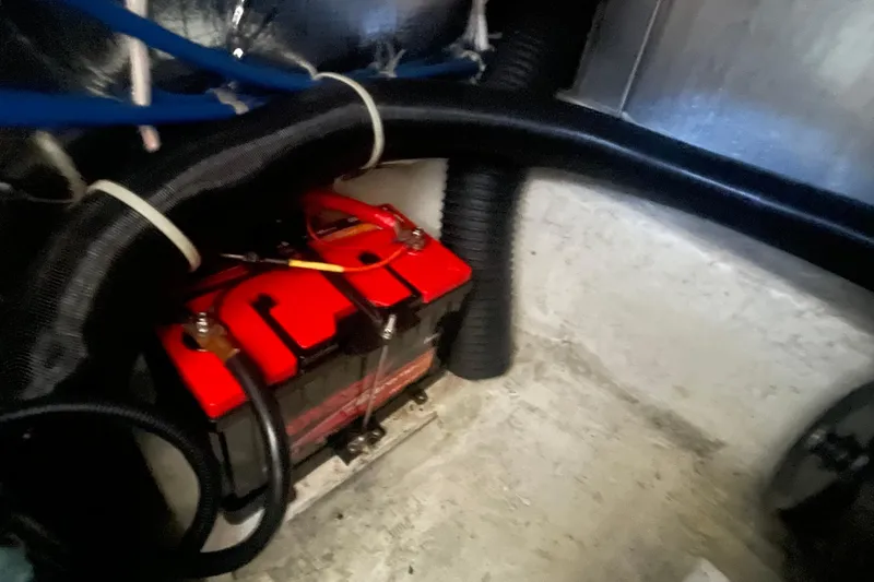Slide: The Image of Battery compartment of 2002 Carver 346 Aft Cabin with red battery and cables. - 31