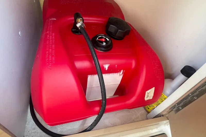 Slide: The Image of Red fuel tank with hose in a 2002 Carver 346 Aft Cabin boat compartment. - 34