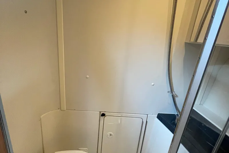 Slide: The Image of 2002 Carver 346 Aft Cabin bathroom with shower and storage. - 35