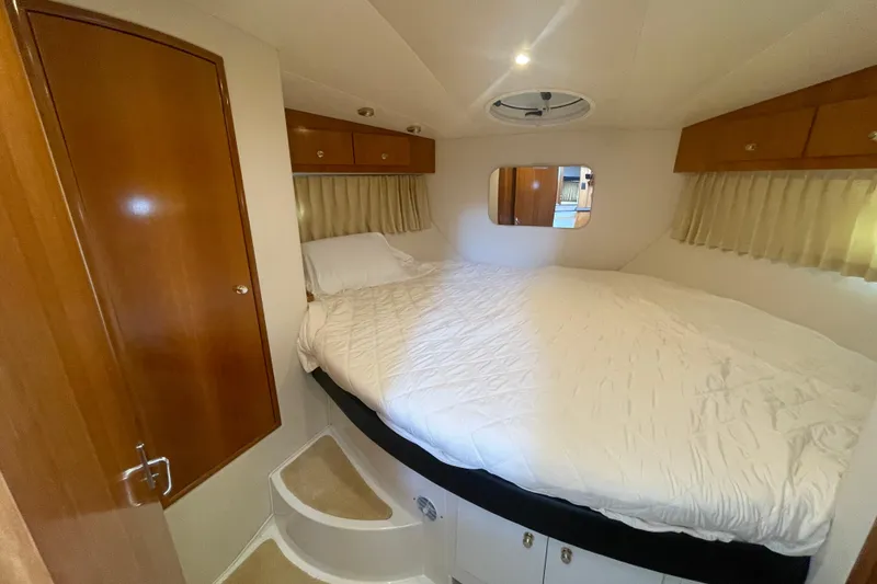 Slide: The Image of Cozy bedroom in 2002 Carver 346 Aft Cabin yacht with wood accents and circular steps. - 38