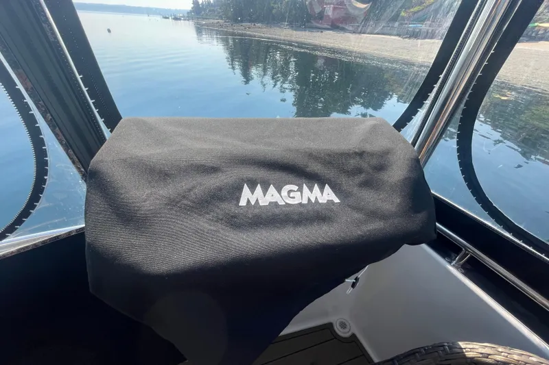 Slide: The Image of 2002 Carver 346 Aft Cabin with Magma grill cover, scenic waterfront view. - 4