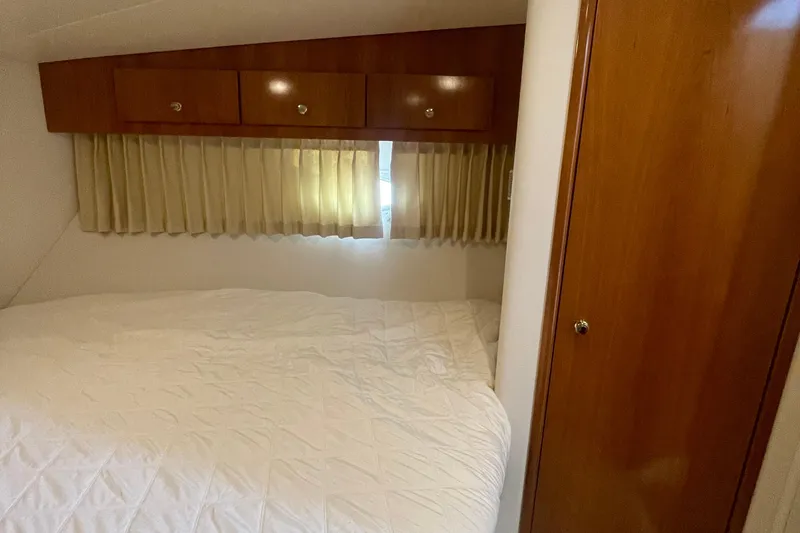 Slide: The Image of Cozy bedroom in 2002 Carver 346 Aft Cabin with wood cabinets and soft lighting. - 40