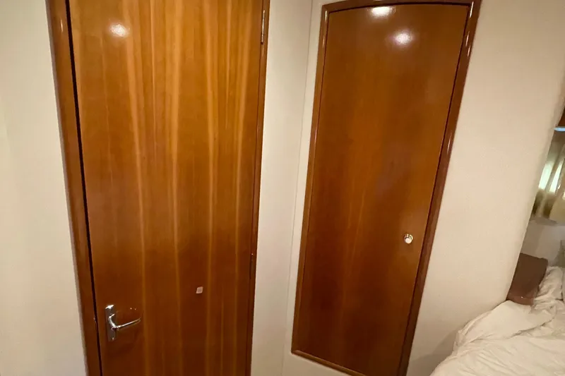 Slide: The Image of Interior of 2002 Carver 346 Aft Cabin with wooden doors and cozy bedroom. - 41