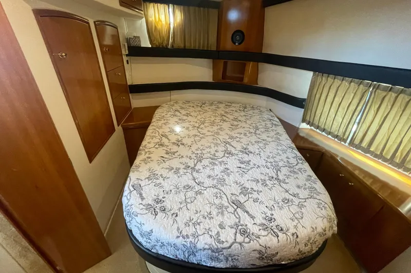 Slide: The Image of Cozy bedroom in 2002 Carver 346 Aft Cabin with floral bedding and wooden cabinetry. - 43
