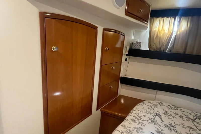 Slide: The Image of 2002 Carver 346 Aft Cabin interior with wooden cabinets and floral bedding. - 45