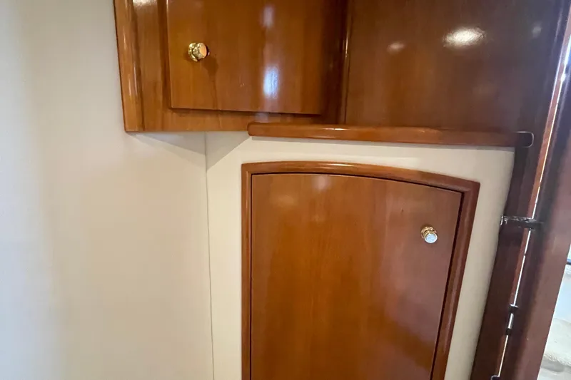 Slide: The Image of Wooden cabinetry inside 2002 Carver 346 Aft Cabin yacht, featuring polished doors and brass knobs. - 46