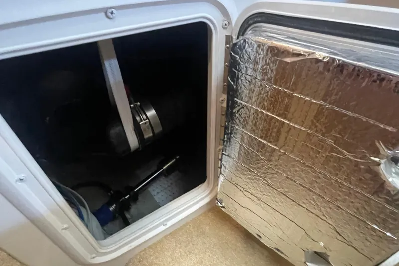 Slide: The Image of Open hatch of 2002 Carver 346 Aft Cabin, showing interior mechanical components. - 51