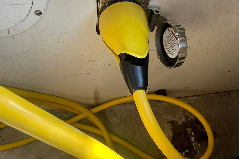 Slide: The Image of Yellow power cable connected to a 2002 Carver 346 Aft Cabin boat. - 54