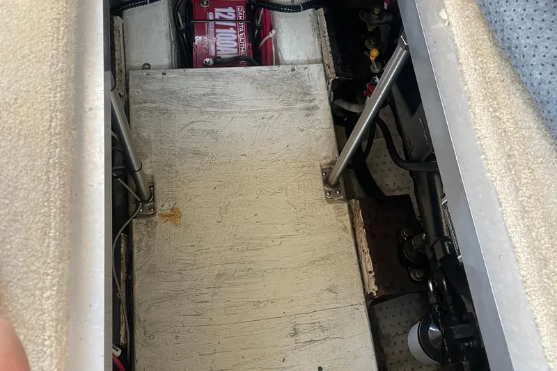 Slide: The Image of Engine compartment of a 2002 Carver 346 Aft Cabin boat, showing battery and mechanical components. - 55