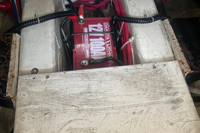 Slide: The Image of Battery compartment of 2002 Carver 346 Aft Cabin with visible wiring and connections. - 56