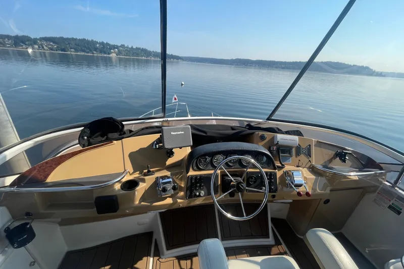 Slide: The Image of Helm of 2002 Carver 346 Aft Cabin yacht with scenic lake view. - 6