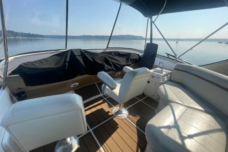 Slide: The Image of 2002 Carver 346 Aft Cabin yacht interior with seating, overlooking calm waters. - 7