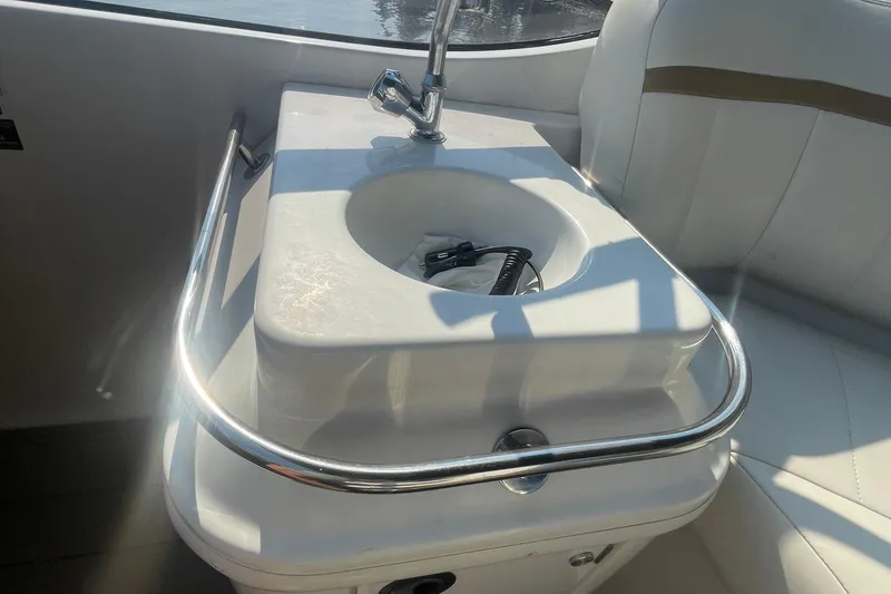 Slide: The Image of 2002 Carver 346 Aft Cabin yacht sink with chrome faucet and railing. - 8