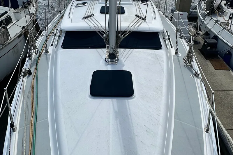 Slide: The Image of 2006 Hunter 41 Deck Salon sailboat docked, showcasing sleek deck design and rigging. - 12