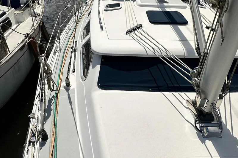 Slide: The Image of 2006 Hunter 41 Deck Salon sailboat with sleek deck design and rigging details. - 13