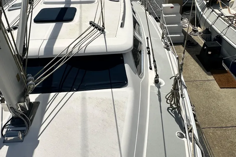 Slide: The Image of 2006 Hunter 41 Deck Salon sailboat docked, showcasing deck and rigging details. - 14