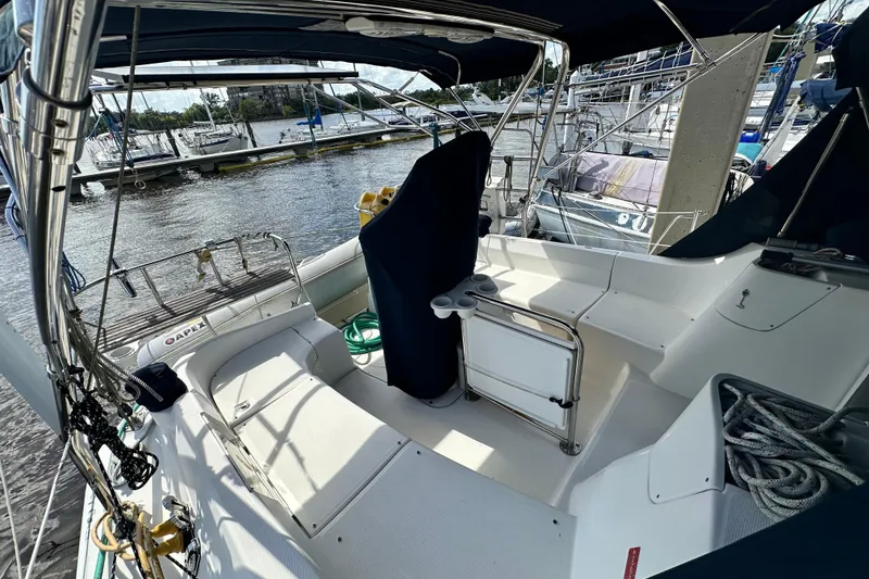 Slide: The Image of 2006 Hunter 41 Deck Salon sailboat cockpit with covered seating and marina view. - 18