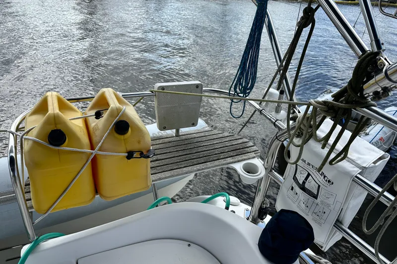 Slide: The Image of Hunter 41 Deck Salon 2006 sailboat deck with yellow fuel containers and ropes. - 22