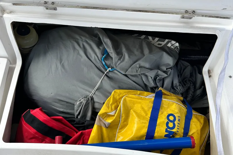Slide: The Image of Storage compartment on a 2006 Hunter 41 Deck Salon sailboat with bags and equipment. - 25