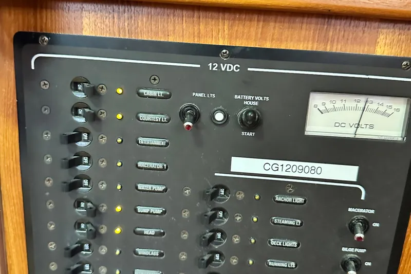 Slide: The Image of Control panel of a 2006 Hunter 41 Deck Salon boat, showing switches and voltmeter. - 27