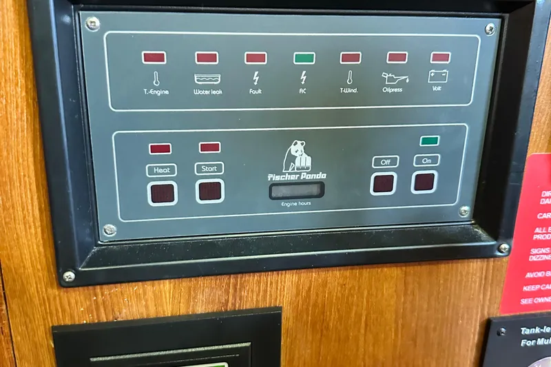 Slide: The Image of Control panel of a 2006 Hunter 41 Deck Salon boat with Fischer Panda display. - 29