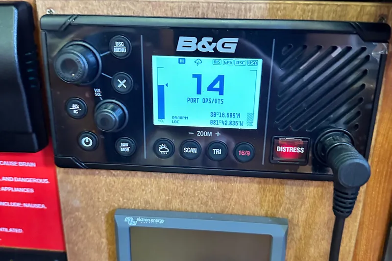 Slide: The Image of B&G marine radio on 2006 Hunter 41 Deck Salon, displaying coordinates and distress button. - 30