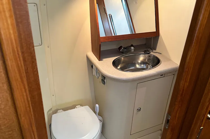 Slide: The Image of 2006 Hunter 41 Deck Salon bathroom with sink, mirror, and toilet. - 37