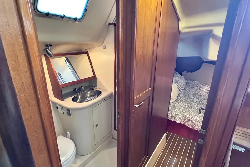Slide: The Image of Interior of 2006 Hunter 41 Deck Salon, featuring bathroom and cozy bedroom. - 38