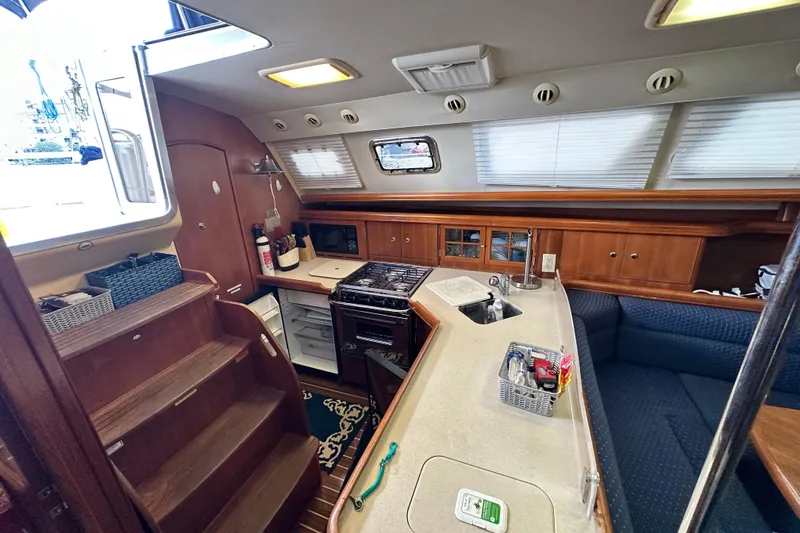 Slide: The Image of Interior of 2006 Hunter 41 Deck Salon yacht with kitchen and seating area. - 39