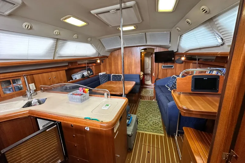 Slide: The Image of Interior of 2006 Hunter 41 Deck Salon yacht with wood finish and modern amenities. - 44