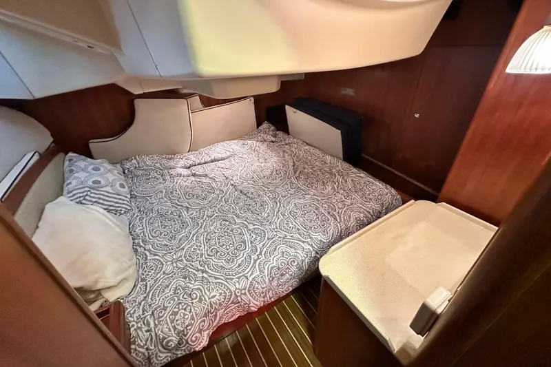 Slide: The Image of Cozy cabin interior of 2006 Hunter 41 Deck Salon with patterned bedding and wooden accents. - 45