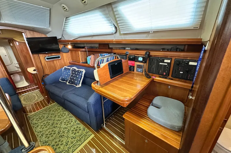 Slide: The Image of Interior of 2006 Hunter 41 Deck Salon with cozy seating and navigation station. - 48