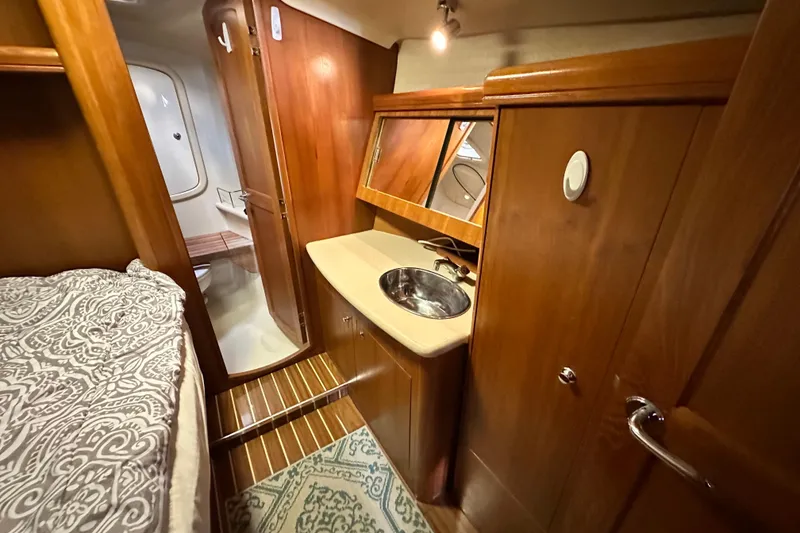 Slide: The Image of Interior of 2006 Hunter 41 Deck Salon with wood finish and compact sink area. - 54