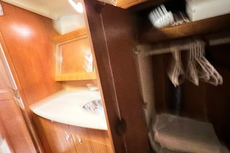 Slide: The Image of 2006 Hunter 41 Deck Salon interior with wooden cabinetry and closet space. - 56