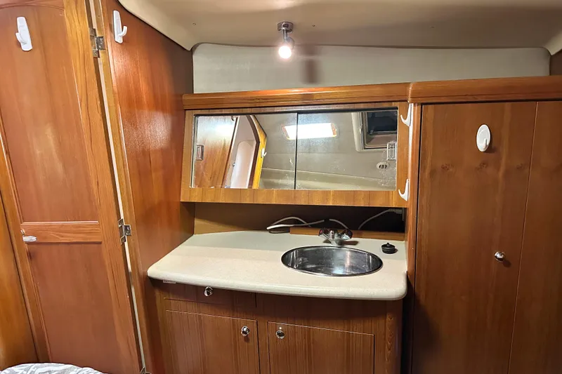 Slide: The Image of Interior of 2006 Hunter 41 Deck Salon with wooden cabinetry and sink. - 58